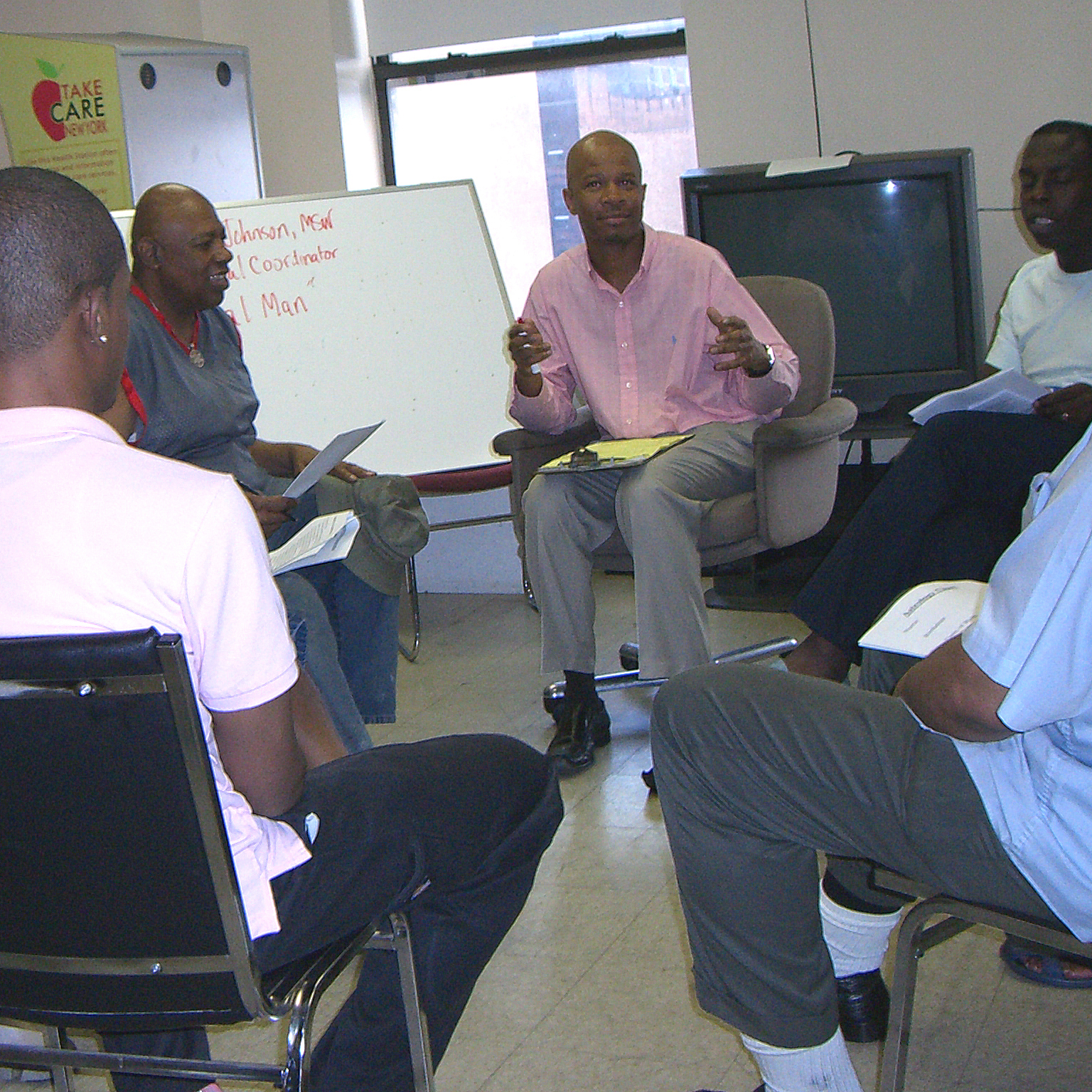Men sitting in a circle and talking Men sitting in a circle and talking