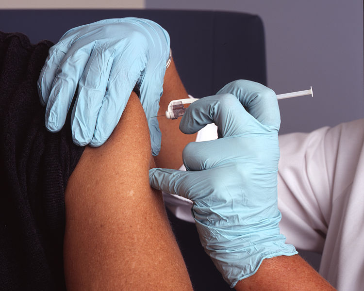 person getting a vaccine by shot